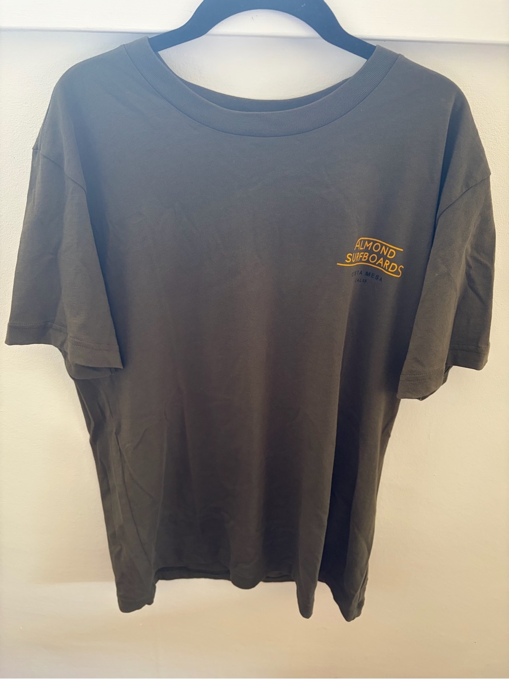 Almond Surfboards T-shirt with yellow text reading 'ALMOND SURFBOARDS'